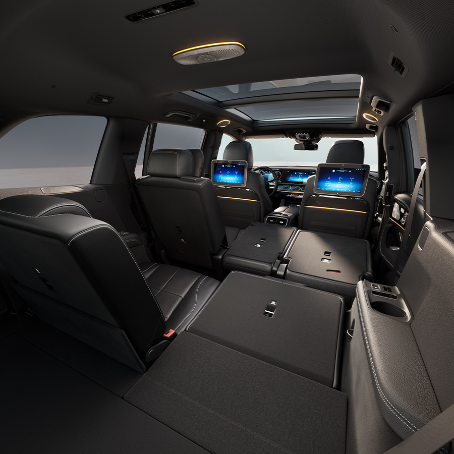 Interior of 2026 Mercedes-Benz GLS with rear seats folded flat showing spacious cargo area and cabin layout.