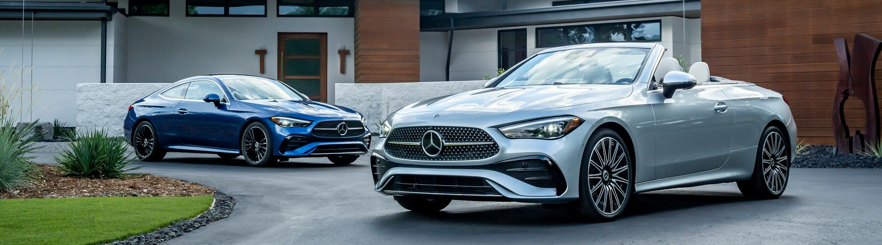 Two Mercedes-Benz Sedans parked