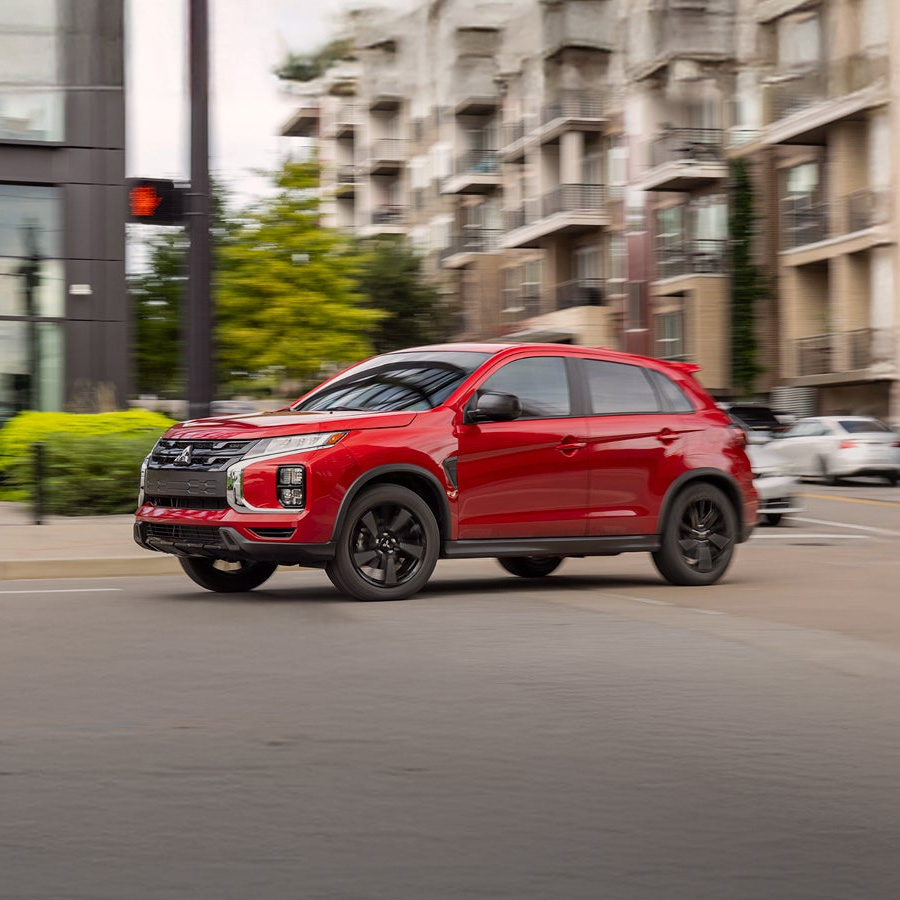 2026 Mitsubishi Outlander Sport in motion driving through the city