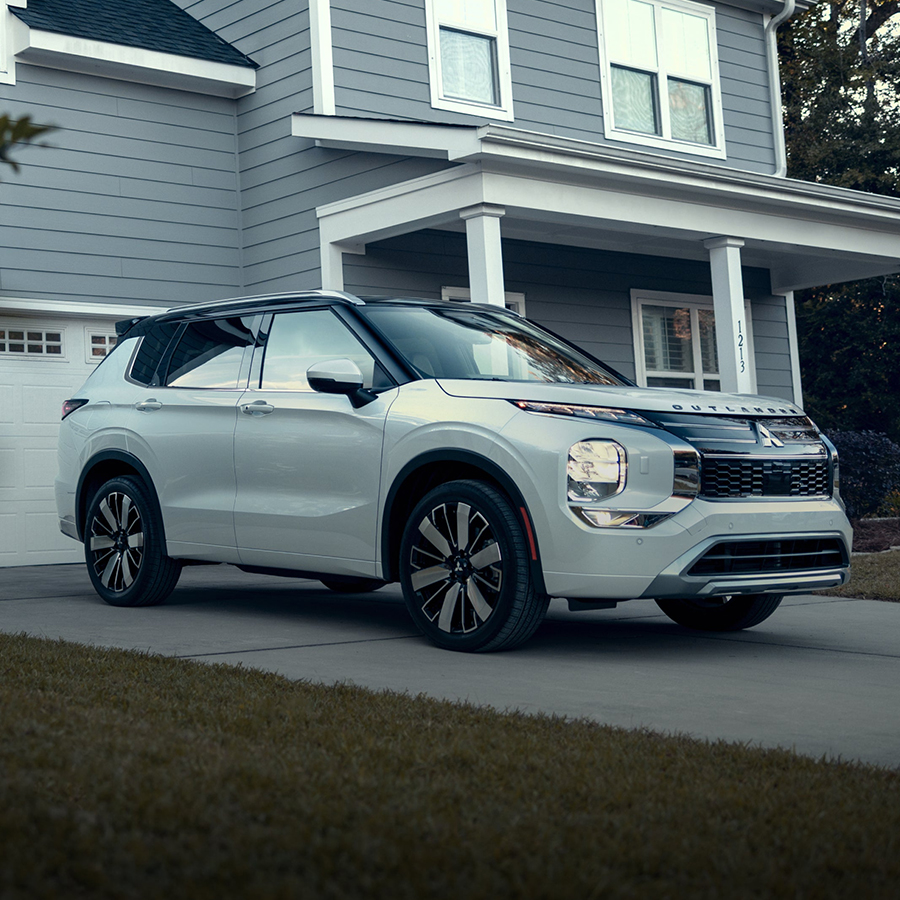A 2026 Mitsubishi Outlander parked outside a residential home