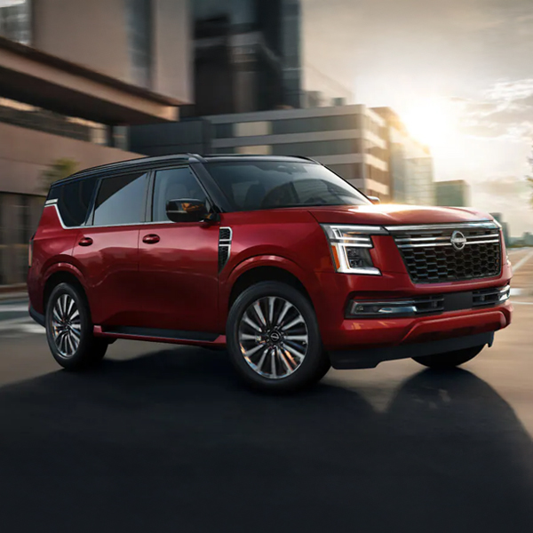 2026 Nissan Armada driving through a city center showing a contrasting roof