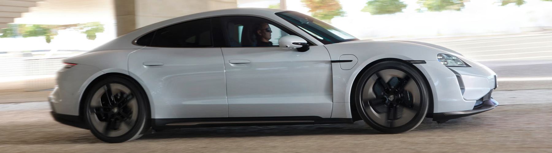 Side profile view of the Porsche Taycan in motion