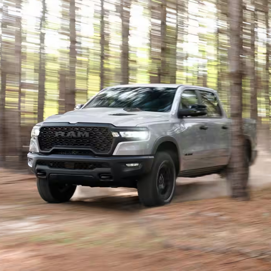 2026 Ram 1500 Crew Cab being driven through woods.