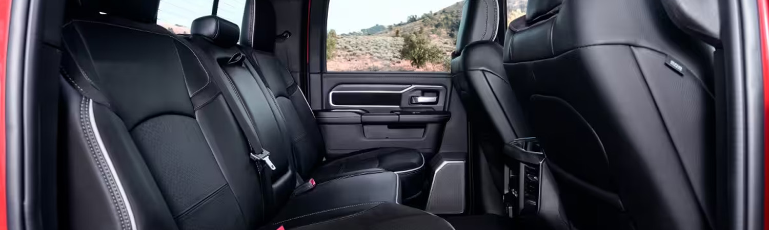 The rear seats in a red 2026 Ram 2500 Laramie.