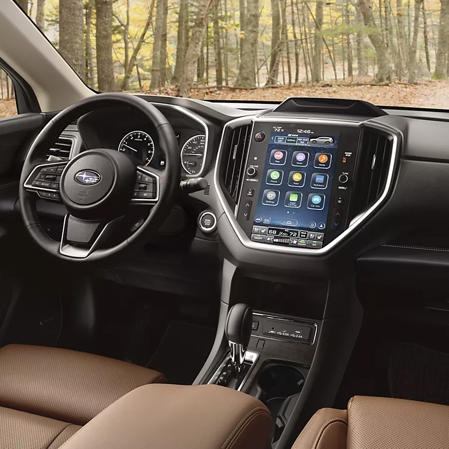 2026 Subaru Ascent cockpit view: Steering wheel, touchscreen, digital cluster, and center console.