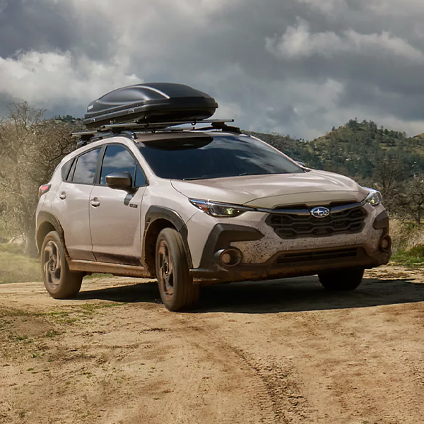 Front 3/4 shot of the 2026 Subaru Crosstrek Hybrid turning on dirt road