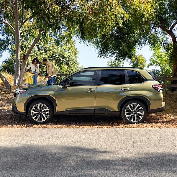 The 2026 Subaru Forester Hybrid parked on the side of a wooded street
