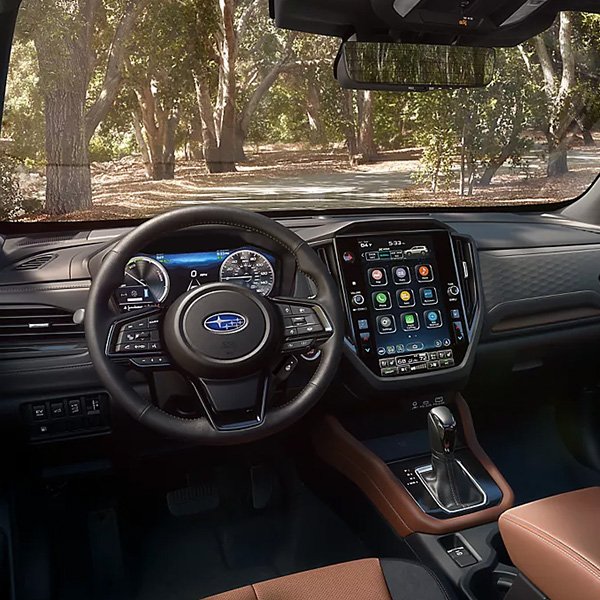 The interior dashboard and steering wheel of the 2026 Subaru Forester Hybrid