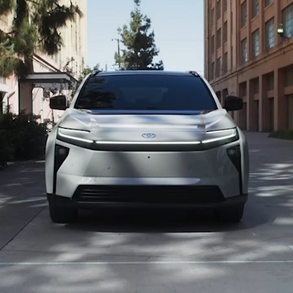 Head on shot of the 2026 Toyota bZ charging at station on the side of the road.