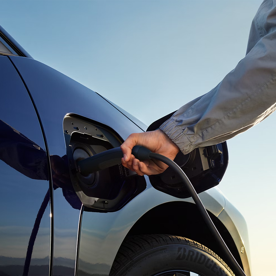 Person charging Toyota EV vehicle