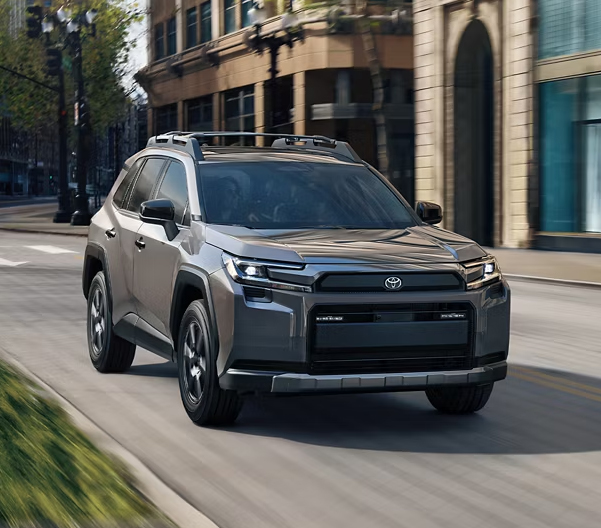 Grey 2026 Toyota RAV4 racing down an urban street