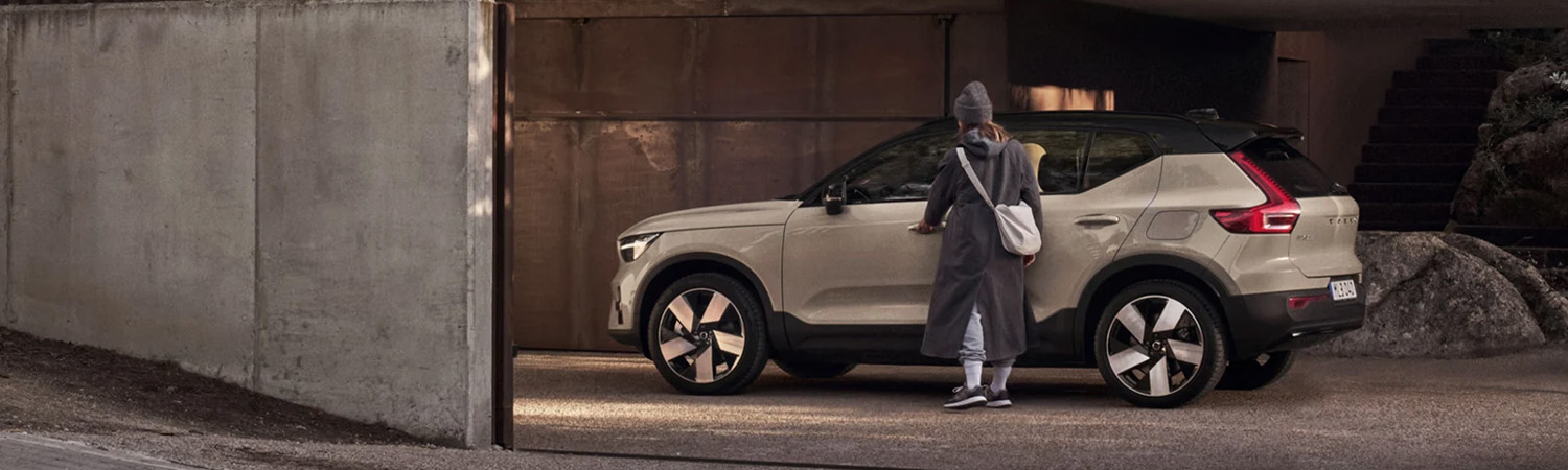 2026 Volvo EX40 parked in a garage with a women getting into the car