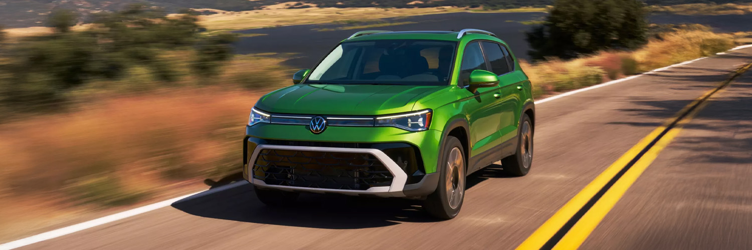 Green VW 2026 Taos driving on a road