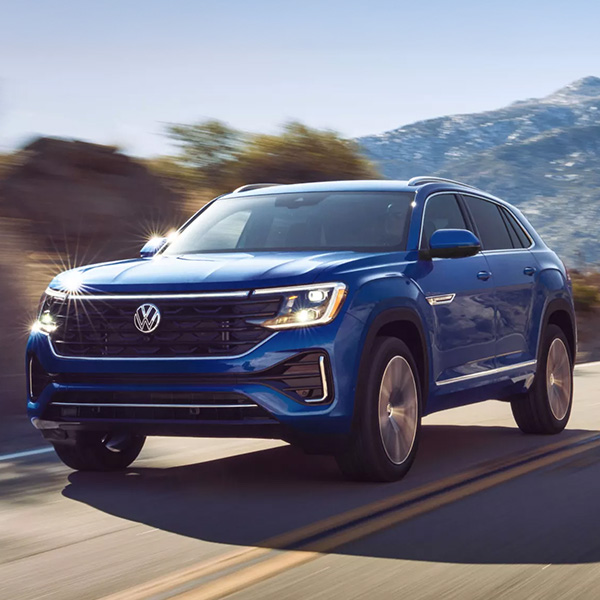 A front view of an Atlas Cross Sport in action shown in Mountain Lake Blue