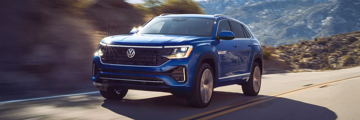 Front 3/4 shot of the 2026 Volkswagen Atlas driving down road