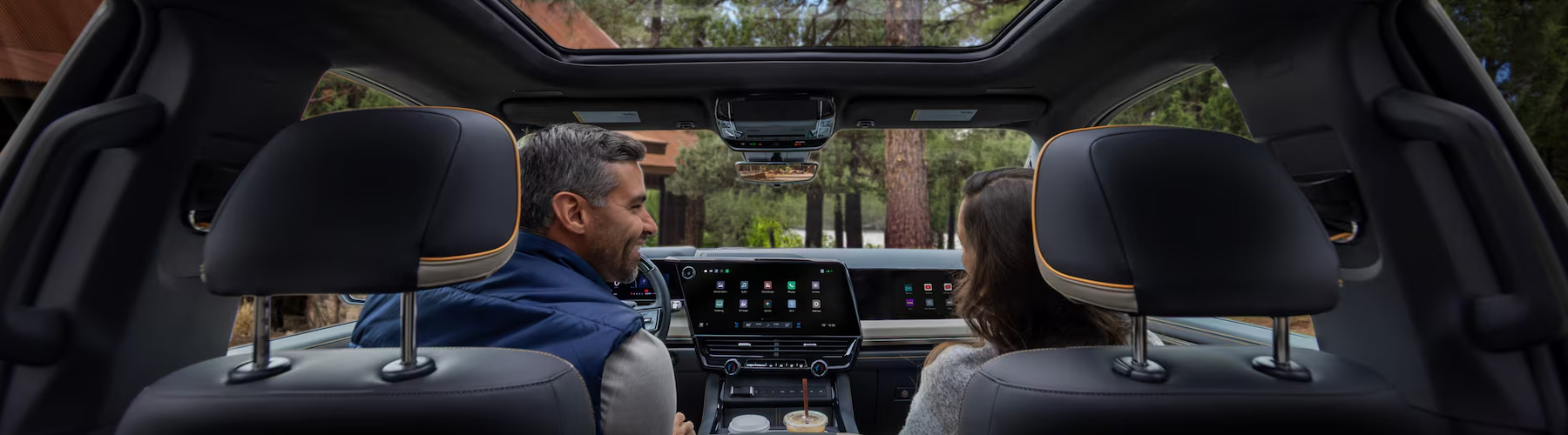 Passenger Seat View of a Man Smiling and Utilizing the Super Cruise Hands-free Technology While Driving a Chevy Silverado