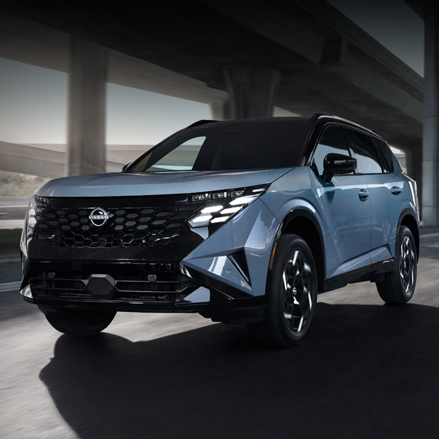 2027 Nissan Rogue Hybrid driving beneath an overpass