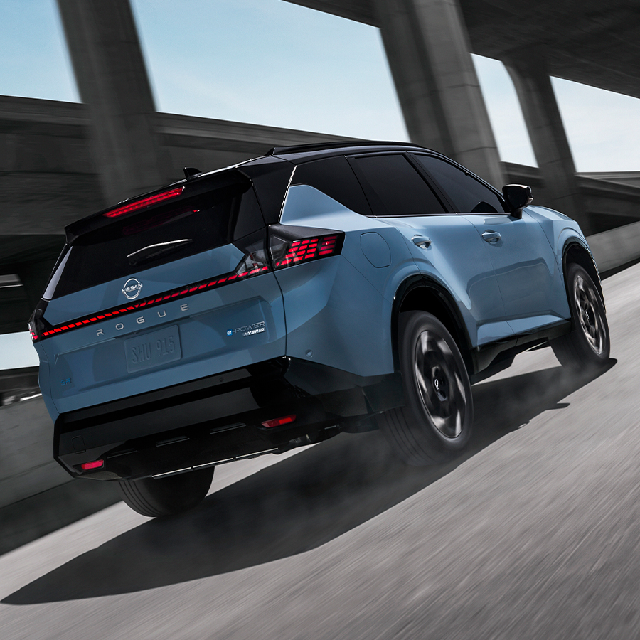 Rear three-quarter view of the 2027 Nissan Rogue e-POWER Hybrid in motion