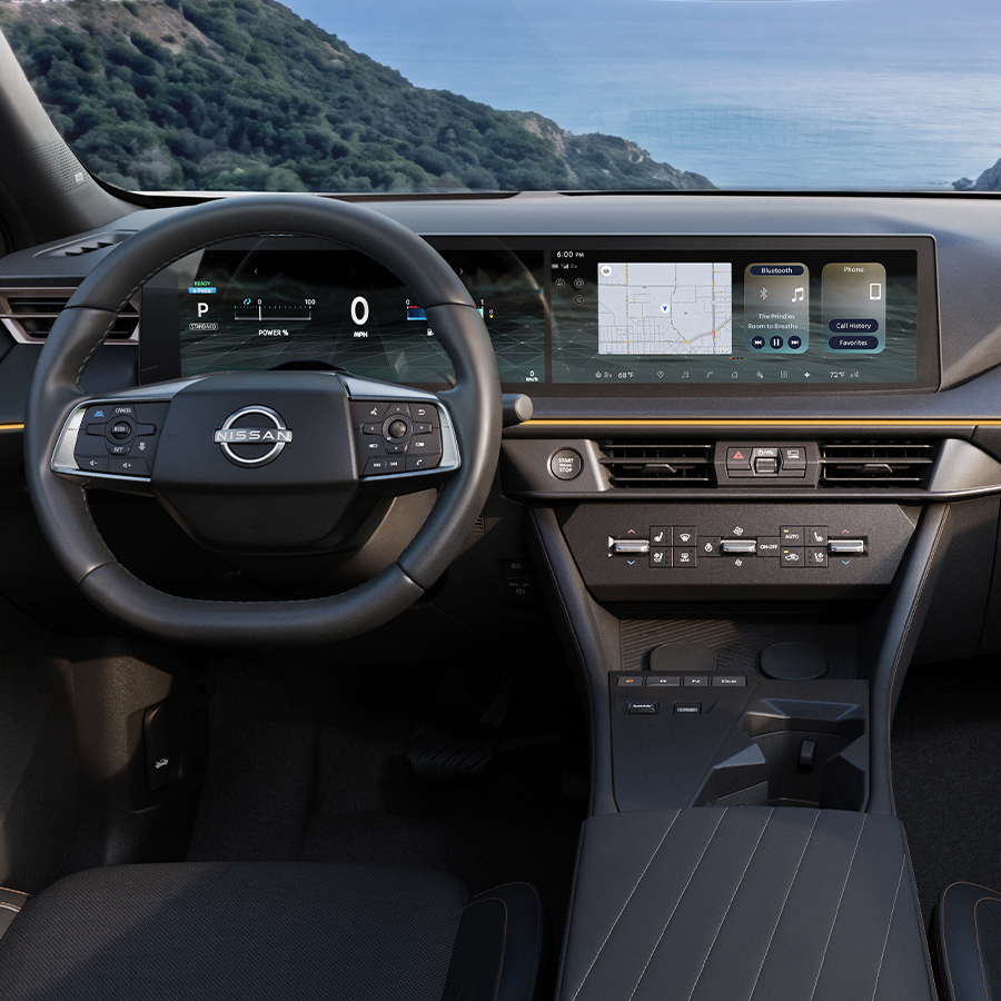 Interior of the 2027 Nissan Rogue Hybrid showing the steering wheel, dashboard, and center console
