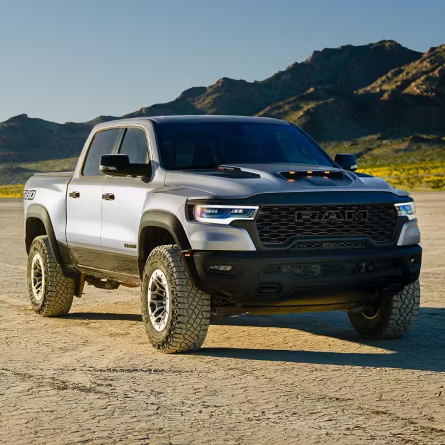 Display A silver 2027 Ram 1500 RHO 4x4 Crew Cab parked in a clearing.