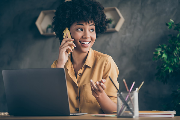 Photo of cheerful positive woman talking on the phone