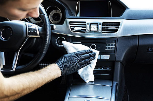 Cleaning the interior of the car with a microfiber cloth