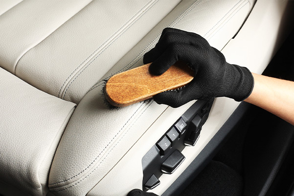 Worker washing of interior leather seats