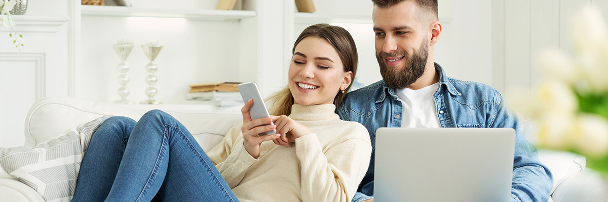 woman showing something on phone to husband