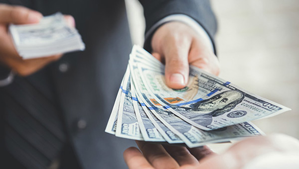 Stack of money being handed over.