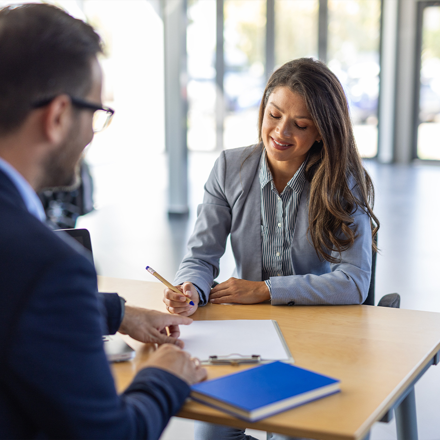 Young woman signing car insurance document or lease paper contract or agreement.