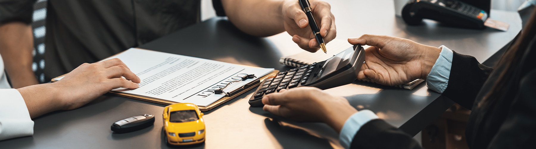 Car dealer calculate interest rate and costs of car loan with calculator, explaining details to customer on term and agreement in dealership office