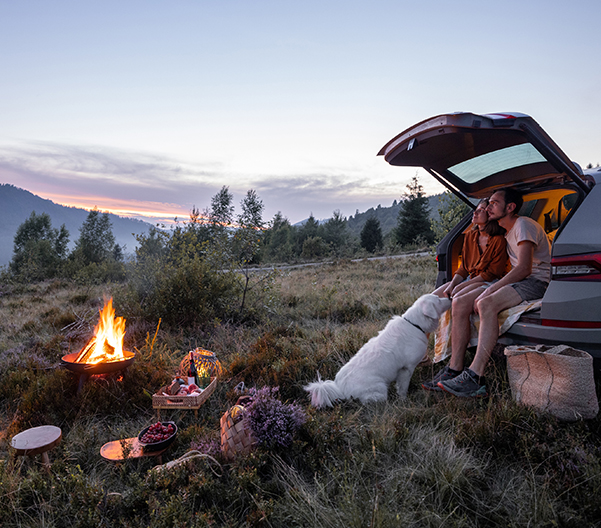 Couple by the fire at picnic in the mountains