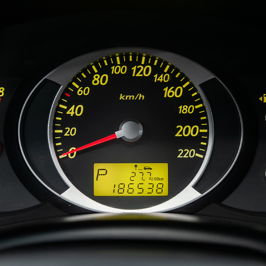 ?lose-up of the car black interior: dashboard, speedometer and tachometer with green backlight and other buttons.