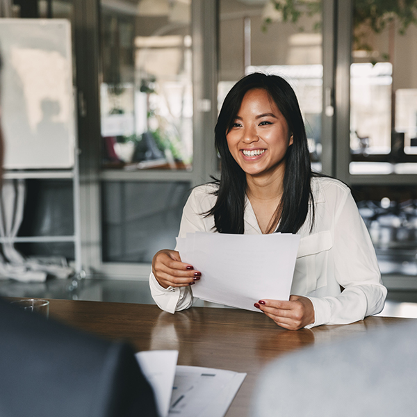 woman smiling sitting during job interview