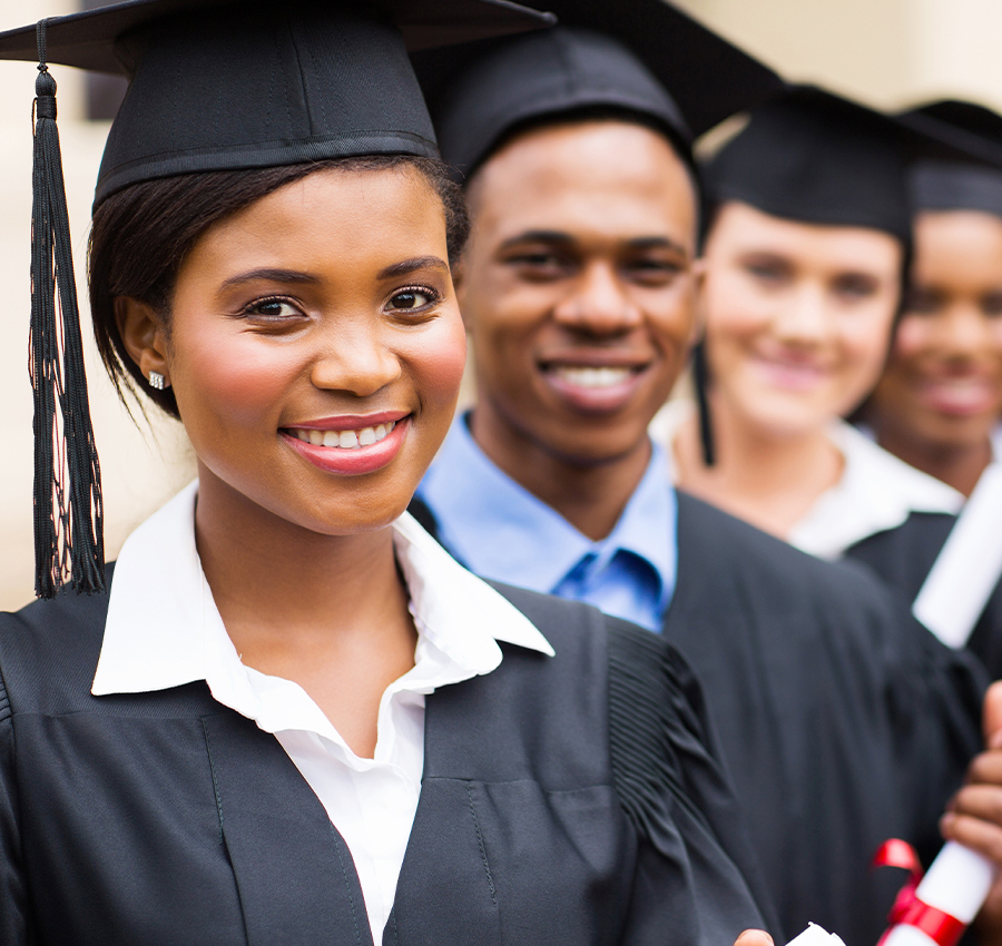 Lineup of college graduates smiling