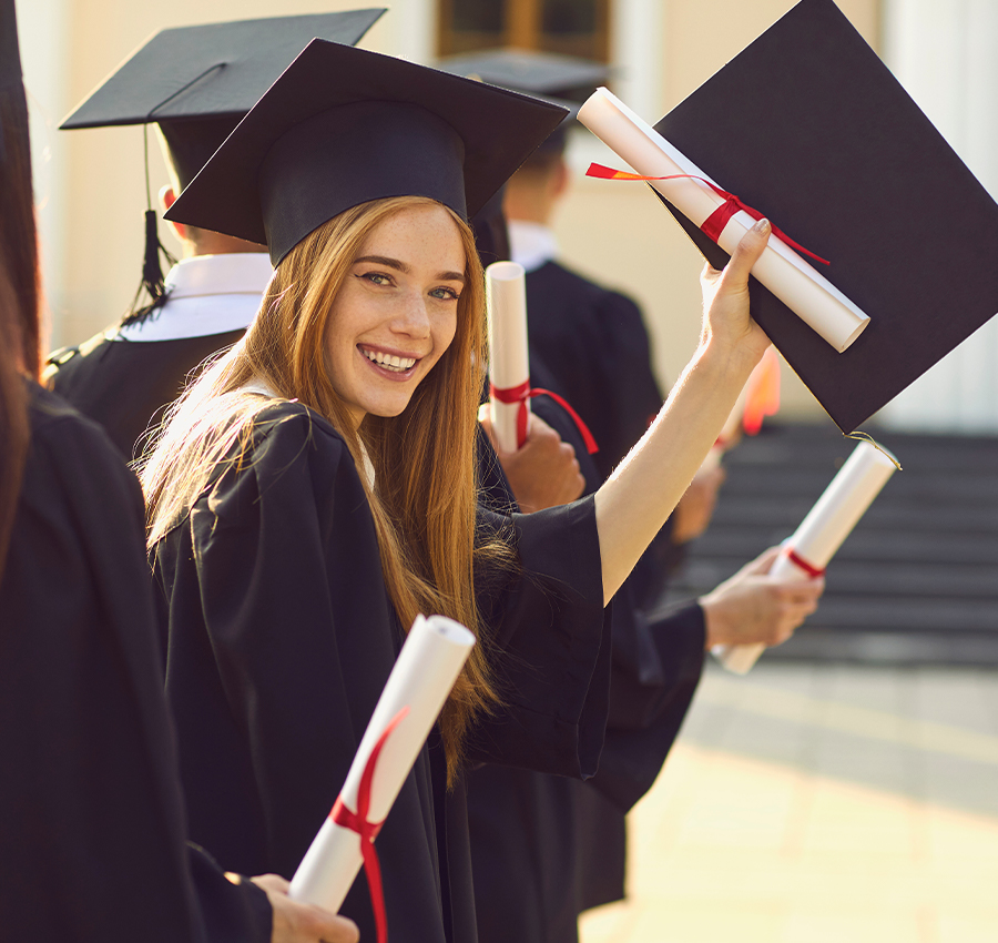 College Graduate smiling holding diploma