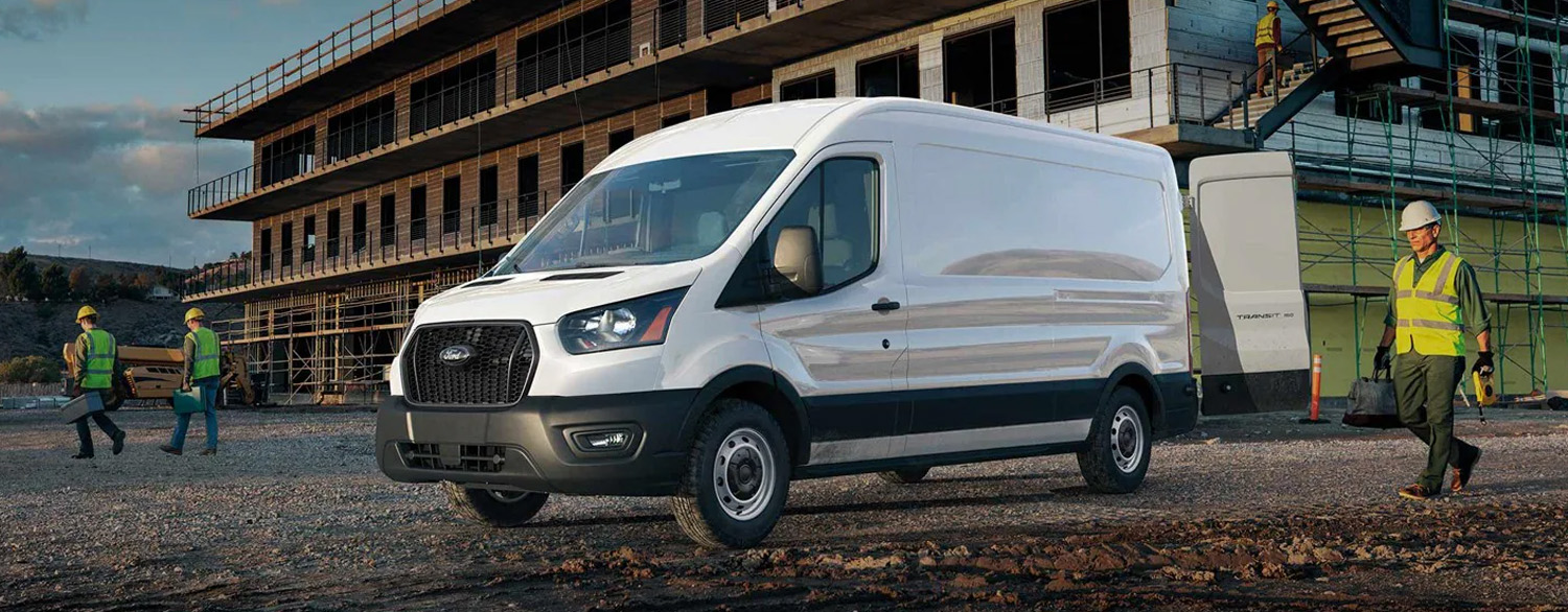 2025 Ford Transit® van parked in front of construction site with workers nearby