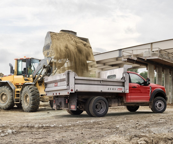2025 Ford Super Duty® Chassis Cab with snowplow upfit pushing a pile of snow