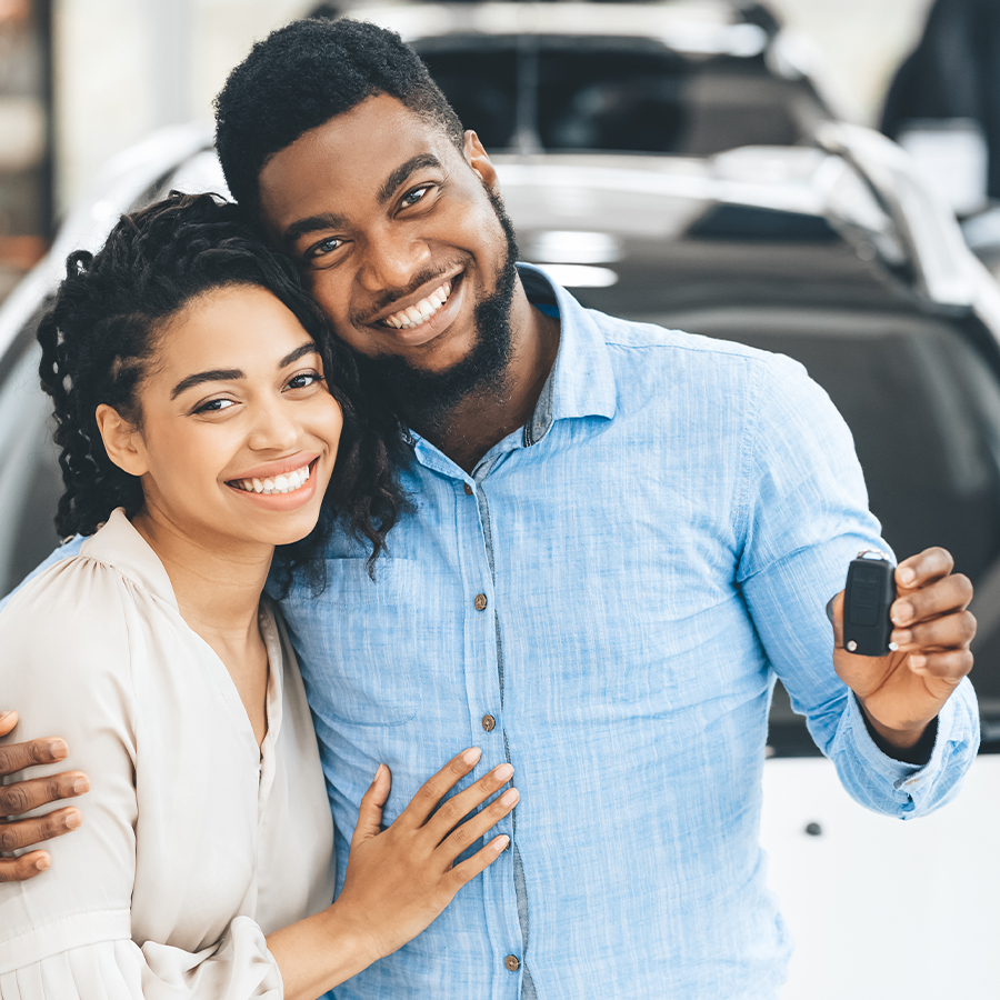 happy couple buyig new car
