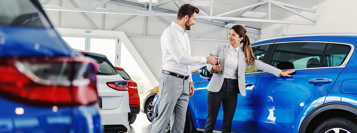 Customer with salesperson at car dealership