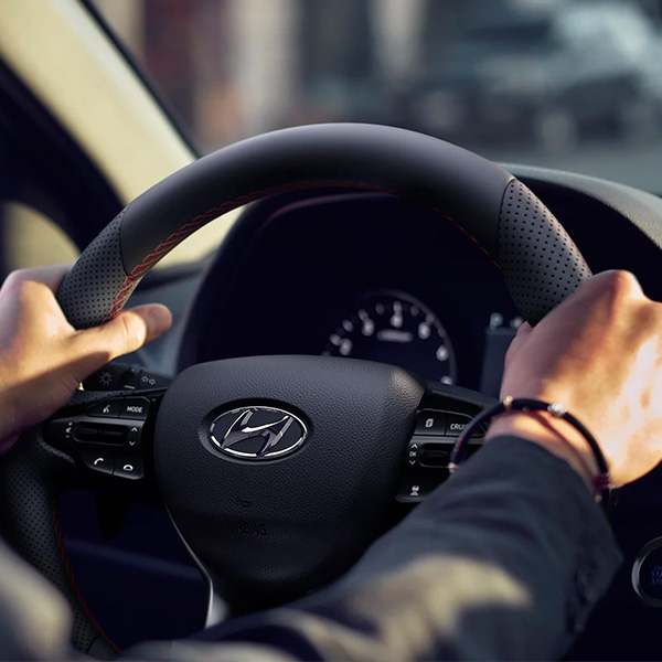 Close up of two hands on a Hyundai steering wheel