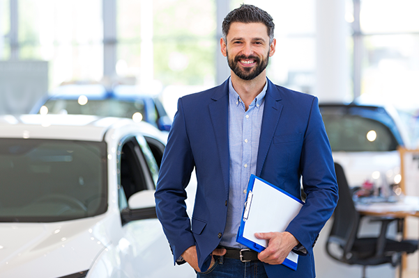 MSales Representative smiling in a bright showroom.
