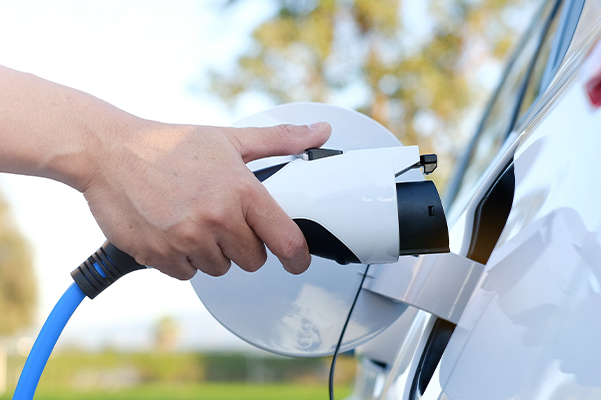 EV charging plug being placed on the car to start charging