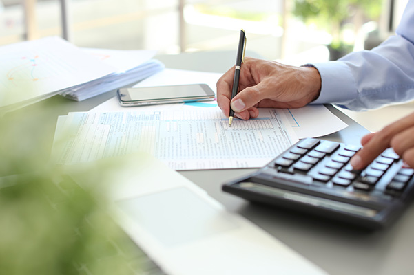 Close up of financial documents and a calculator