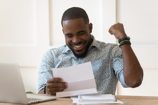 Person looking at documents and smiling with hand help up