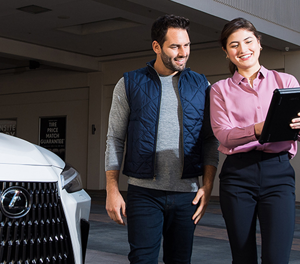 Woman showing a Lexus customer an iPad