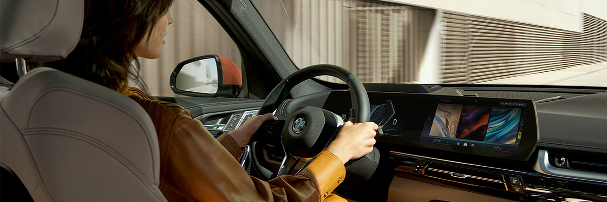 woman standing outside of a bmw
