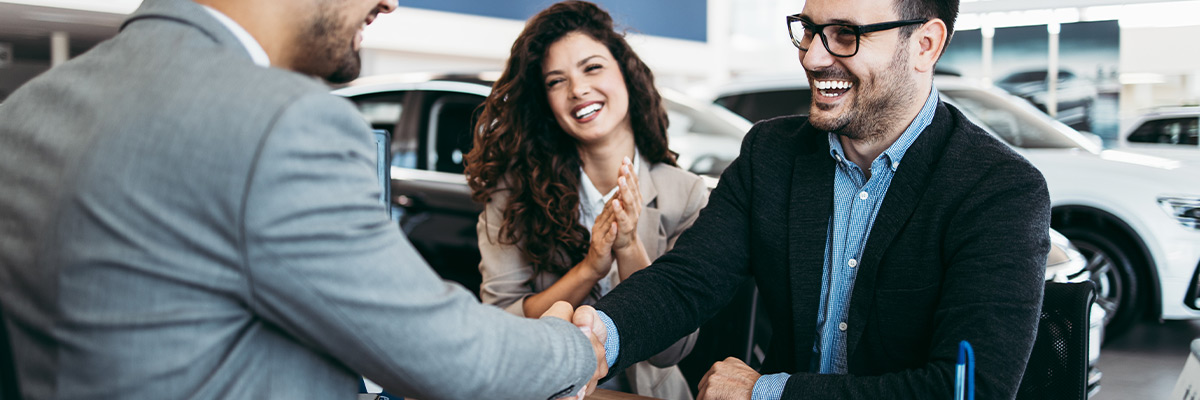 Happy customers at car dealership