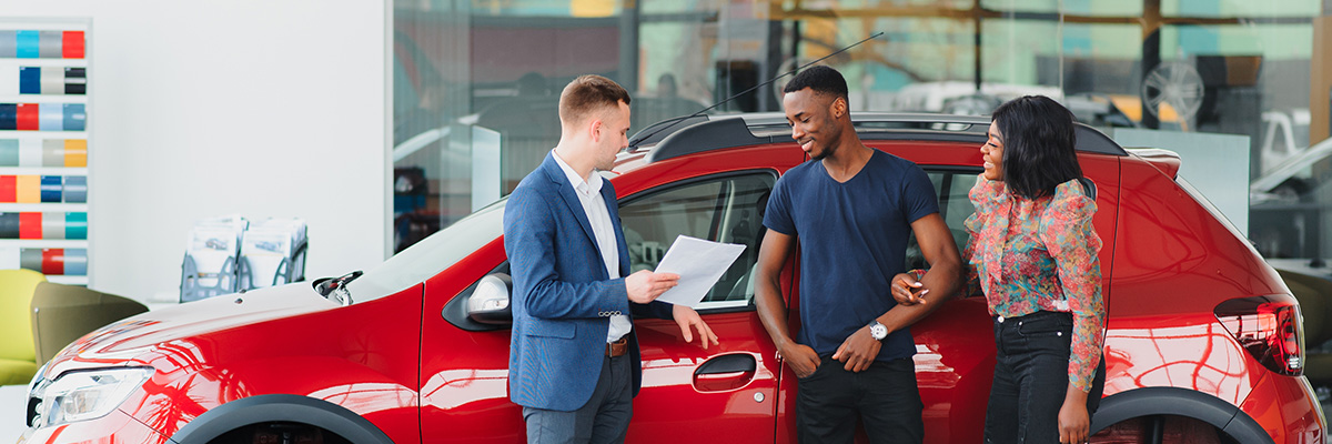 People talking with dealership employee