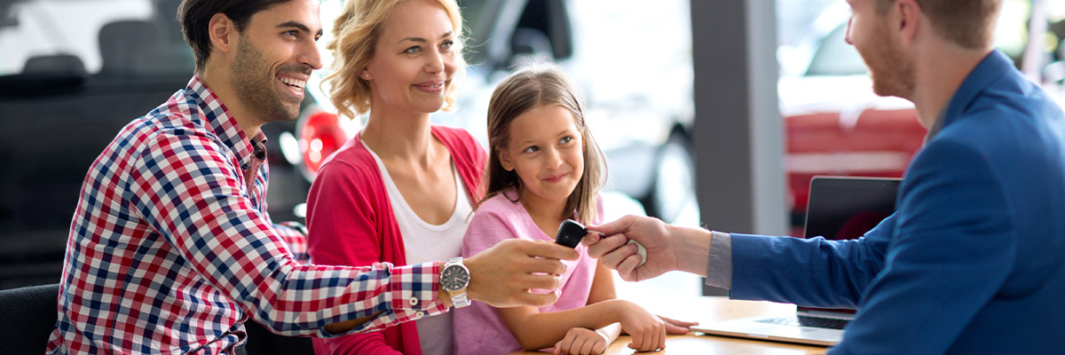 Happy family being handed car keys